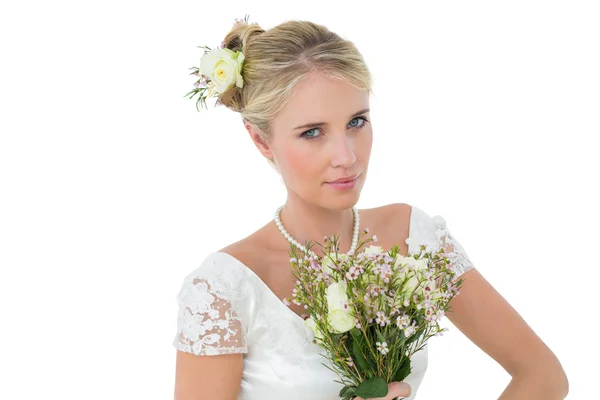 Bride holding bouquet against white background — Stock Photo, Image