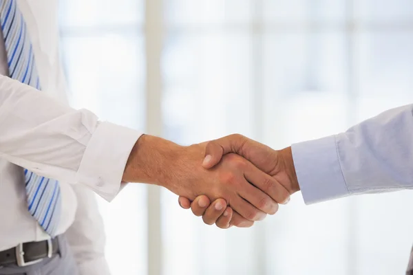 Close-up shot of a handshake in office — Stock Photo, Image