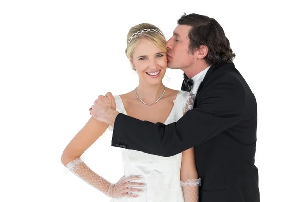 Bride being kissed by groom — Stock Photo, Image