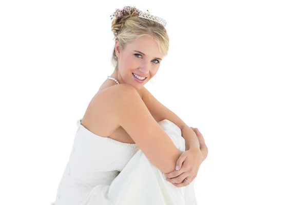 Young bride hugging knees over white background — Stock Photo, Image