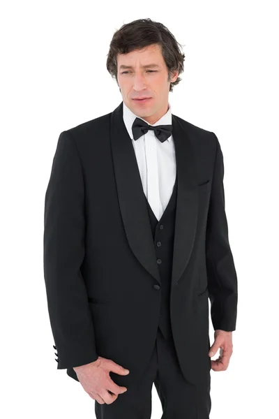 Anxious groom in tuxedo looking down — Stock Photo, Image