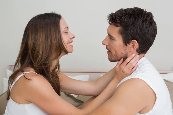 Loving couple looking at each other at home — Stock Photo, Image