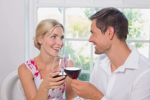 Loving couple with wine glasses looking at each other — Stock Photo, Image