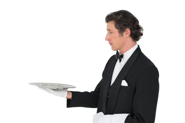 Handsome server holding tray over white background — Stock Photo, Image