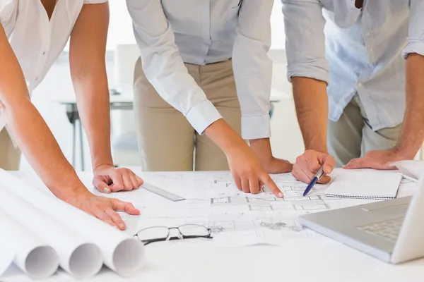 Mid section of business people working on blueprints at office — Stock Photo, Image