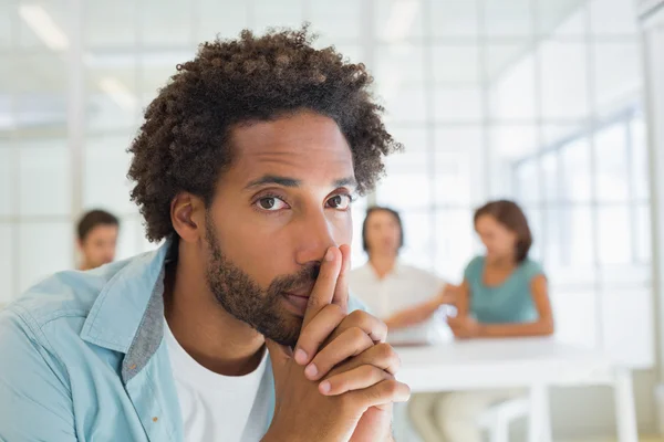 Portrait of a serious businessman with colleagues in meeting — Stock Photo, Image