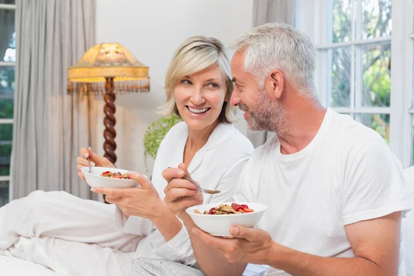 Mature couple having breakfast in bed — Stock Photo, Image