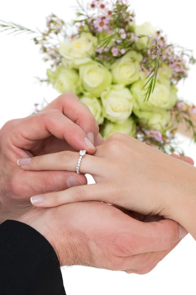 Cropped image of groom and bride exchanging ring — Stock Photo, Image