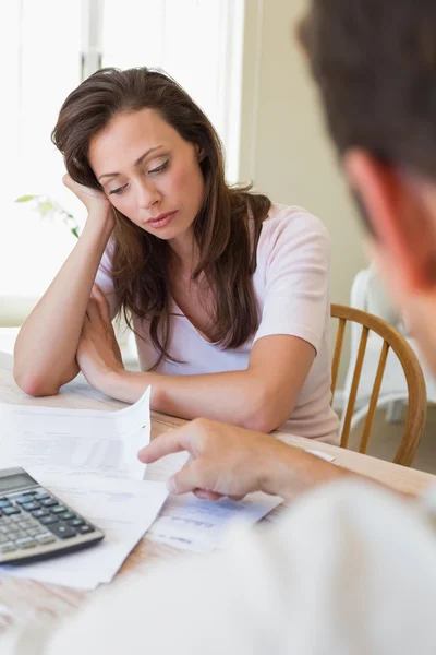 Upset young woman and man with home bills — Stock Photo, Image