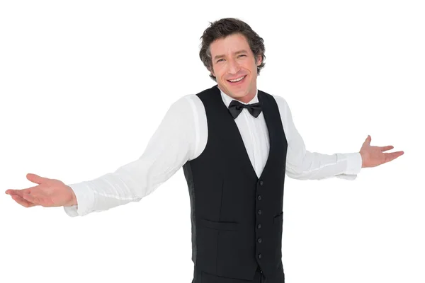 Smiling waiter shrugging over white background — Stock Photo, Image