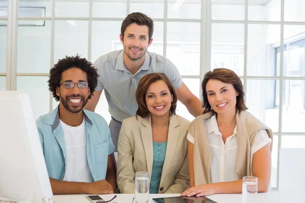 Business people smiling at office desk — Stock Photo, Image