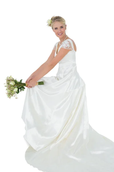 Happy bride holding bouquet over white background — Stock Photo, Image