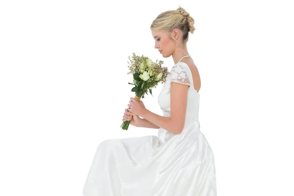 Bride holding flower bouquet over white background — Stock Photo, Image