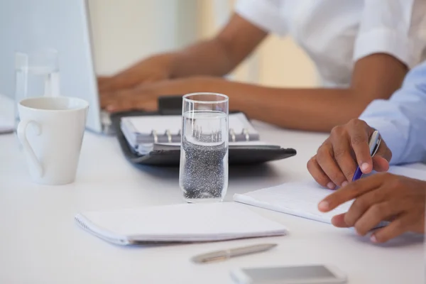 Mid section of business people in meeting Royalty Free Stock Photos