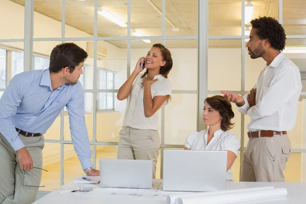 Woman on call amid business meeting at office Stock Picture