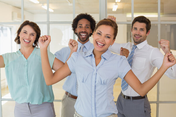 Cheerful business colleagues cheering in office Stock Image