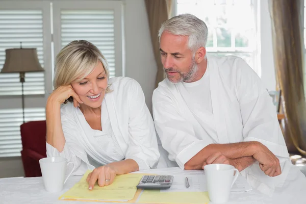 Casual mature couple with home bills and calculator Stock Image