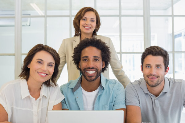 Portrait of smiling business people using laptop Royalty Free Stock Images