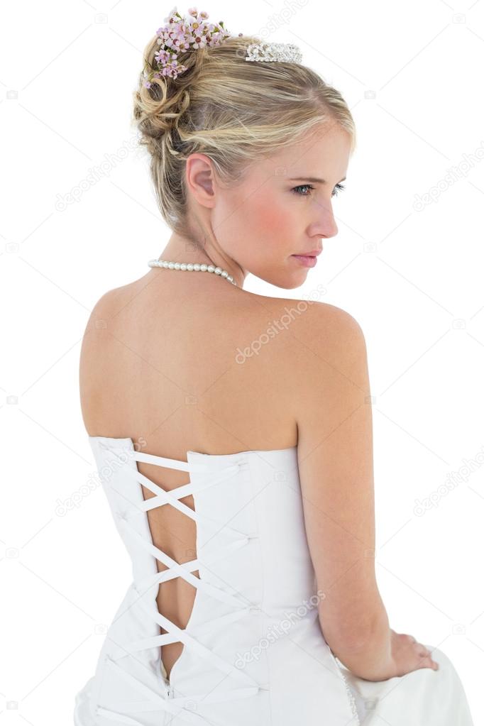 Bride in off shoulder dress looking away