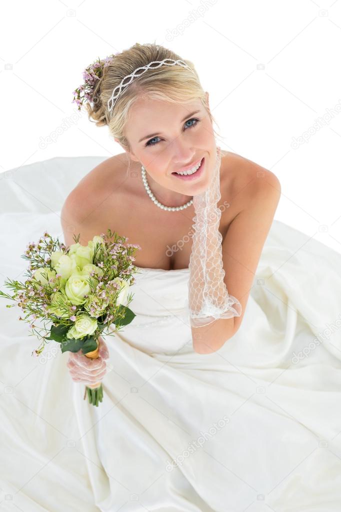 Portrait of smiling bride holding flower bouquet