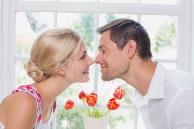 Side view of a romantic couple rubbing noses clipart