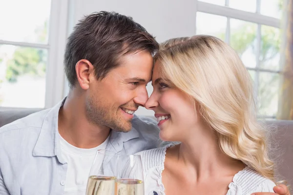 Loving couple with champagne flutes at home — Stock Photo, Image