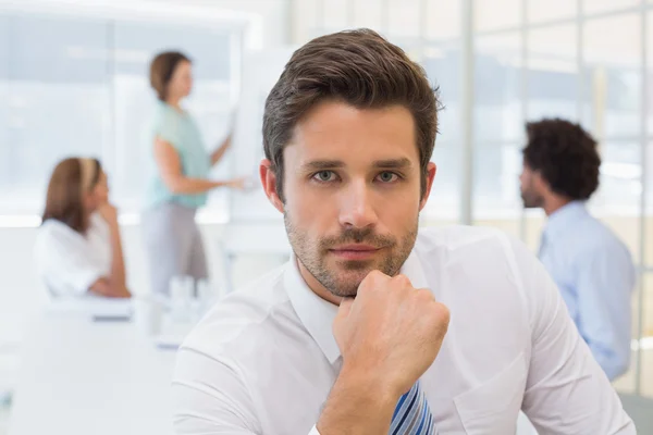 Serious businessman with colleagues in meeting at office — Stock Photo, Image