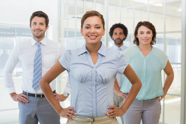 Smiling young businesswoman with colleagues — Stock Photo, Image