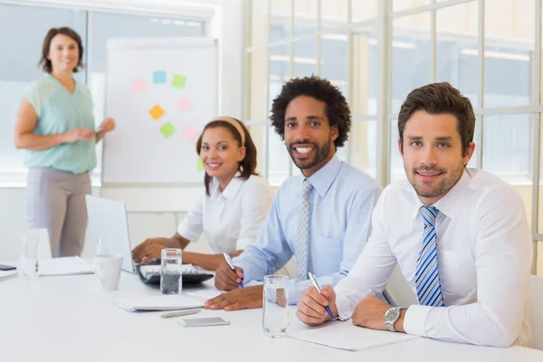 Businesswoman giving presentation to colleagues in office — Stock Photo, Image