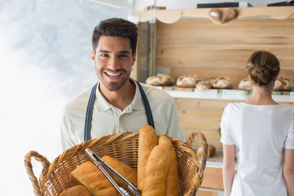 Waiter with basket of breads at the coffee shop — Stock Photo, Image