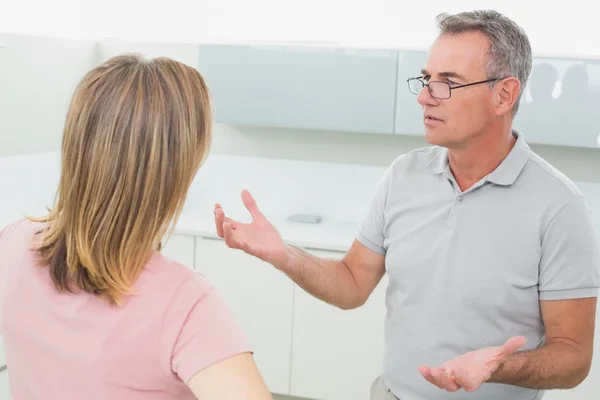 Unhappy couple having an argument in kitchen — Stockfoto