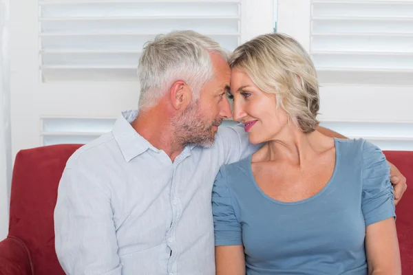 Relaxed mature couple sitting on couch — Stock Photo, Image