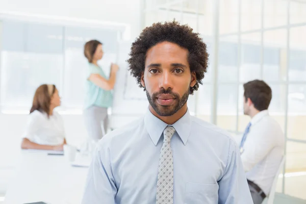 Serious businessman with colleagues in meeting — Stock Photo, Image