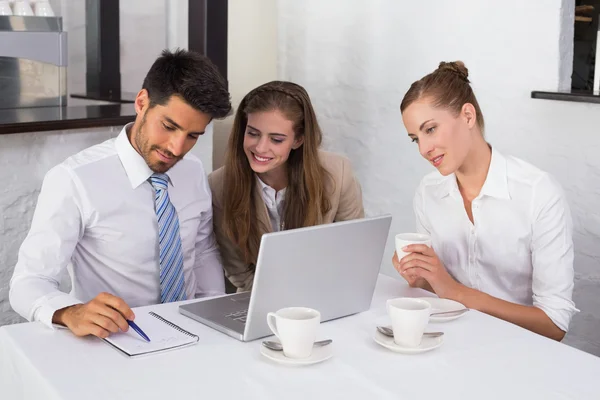 Business people using laptop together at office desk — Stock Photo, Image