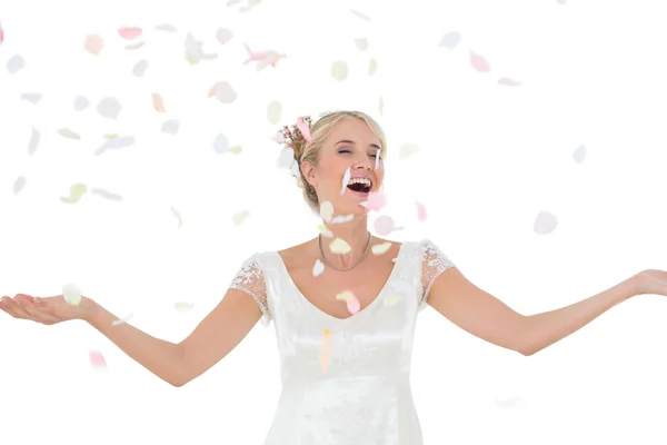 Beautiful bride being showered with petals — Stock Photo, Image