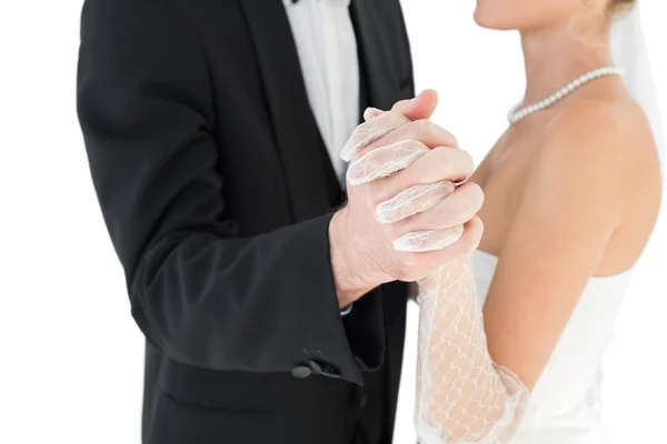 Mid section of bride and groom holding hands — Stock Photo, Image