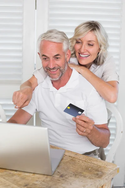 Mature couple doing online shopping at home — Stock Photo, Image