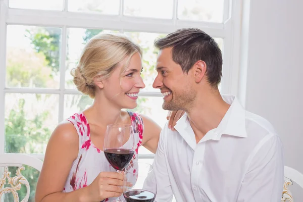 Happy loving couple with wine glasses looking at each other — Stock Photo, Image