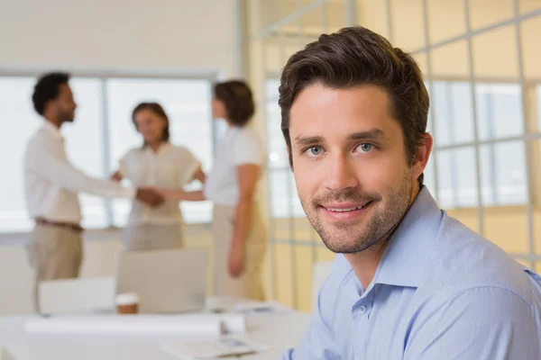 Businessman with colleagues hand shaking at office — Stock Photo, Image