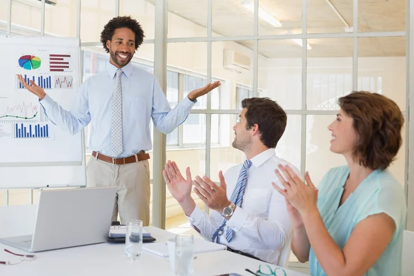 Businessman giving presentation to colleagues in office — Stock Photo, Image