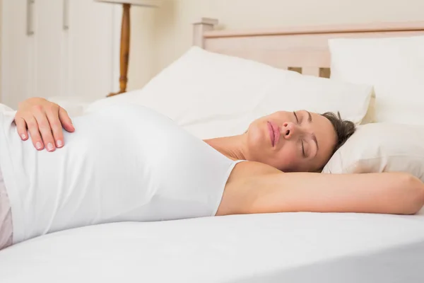 Relaxed woman sleeping in bed — Stock Photo, Image
