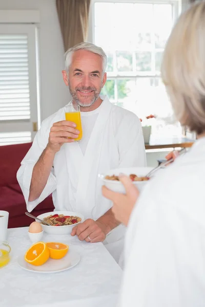Mature man having breakfast with cropped woman — Stock Photo, Image