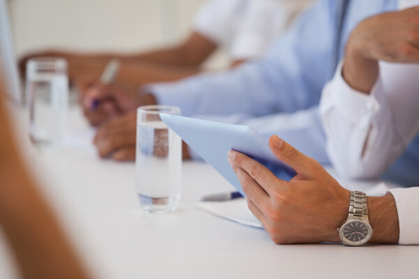 Mid section of business people in meeting Stock Photo