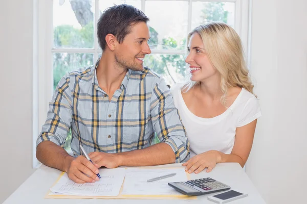 Couple with financial documents and calculator at home — Stock Photo, Image