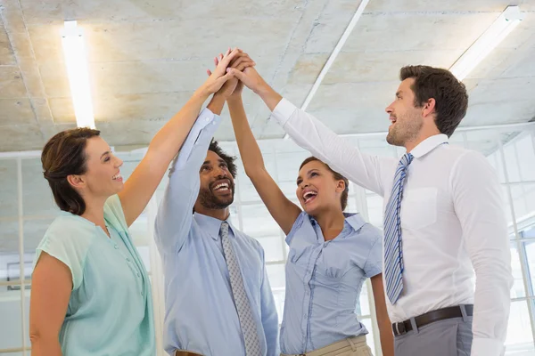 Business team joining hands together in office Stock Picture