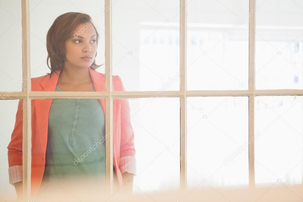 Serious businesswoman looking away at office