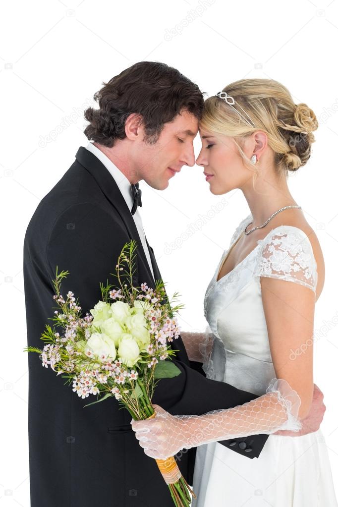 Newlywed couple standing head to head