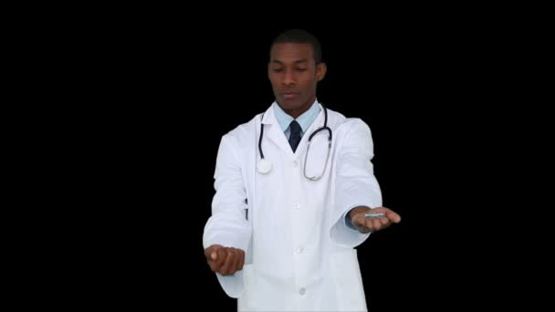 Serious young doctor showing tablets — Stock Video