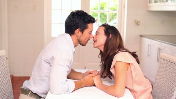 Happy couple kissing at the table — Stock Video