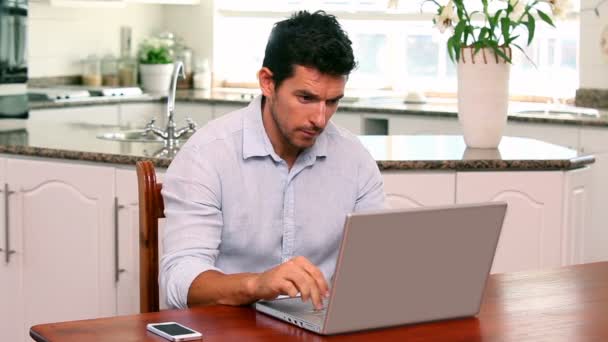 Schöner Mann mit Laptop am Tisch — Stockvideo